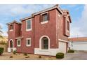 A charming terracotta two-story home, featuring a tiled roof and an attached garage at 924 E Redondo Dr, Gilbert, AZ 85296