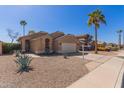 Inviting single-story home featuring desert landscaping and a convenient two-car garage at 9423 E Posada Ave, Mesa, AZ 85212