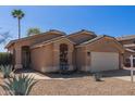 A single story home with an attached garage and a low maintenance desert landscape at 9423 E Posada Ave, Mesa, AZ 85212