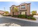 Two-story townhome with stone accents and tasteful landscaping, offering an inviting curb appeal at 1153 E Muirwood Dr, Phoenix, AZ 85048