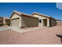 Charming single-story home featuring a two-car garage, walkway, and low maintenance desert landscaping at 12240 W Scotts Dr, El Mirage, AZ 85335