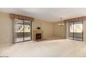 Open living room with fireplace and sliding doors to patio at 15252 N 100Th St # 1151, Scottsdale, AZ 85260