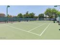 Outdoor tennis court with green surface and surrounding fence and landscaping at 15252 N 100Th St # 1151, Scottsdale, AZ 85260