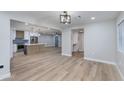 Bright living area featuring hardwood floors, an open layout, and a view of the modern kitchen at 1530 W Glenrosa Ave, Phoenix, AZ 85015