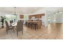 Well-lit kitchen with a central island, bar seating, and an adjacent dining area for Gathering meals at 16510 W Baden Ave, Goodyear, AZ 85338