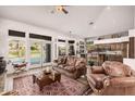 Bright living room with comfortable leather furniture and an easy indoor-outdoor flow to the pool and patio area at 1668 E Saltsage Dr, Phoenix, AZ 85048