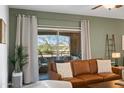 Living room featuring a leather sofa and a balcony view with neutral colored walls at 16801 N 94Th St # 2005, Scottsdale, AZ 85260
