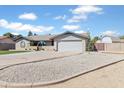 Single-story home boasting a tidy front yard with desert landscaping, a driveway, and a two-car garage at 16824 N 38Th Dr, Phoenix, AZ 85053