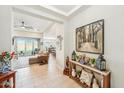 Open-concept entryway leading to a spacious living room and dining area, showcasing the home's seamless flow at 18438 W Brookwood Dr, Goodyear, AZ 85338