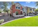 Charming townhome with stucco exterior, well-manicured lawn, and desert landscaping at 1950 N Center St # 101, Mesa, AZ 85201