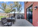 Relaxing outdoor patio with tile flooring, seating, and view of mature trees at 1950 N Center St # 101, Mesa, AZ 85201