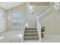 Bright foyer with soaring ceilings, view of second story loft, and a staircase at 20802 N 74Th Ln, Glendale, AZ 85308