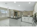 Updated kitchen featuring white cabinets, stylish dark countertops, an island and stainless appliances at 20802 N 74Th Ln, Glendale, AZ 85308