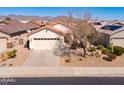 Aerial shot of a home featuring a two-car garage, desert landscaping, and tiled roof at 22520 W Moonlight Path, Buckeye, AZ 85326