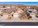 Expansive aerial view of the community showcasing mountain views, solar panels and desert landscaping at 22520 W Moonlight Path, Buckeye, AZ 85326