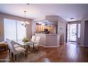 Bright dining area open to kitchen featuring hardwood floors and modern decor at 22520 W Moonlight Path, Buckeye, AZ 85326