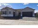 Charming single-Gathering home with gray exterior, paver driveway, well-maintained landscaping, and a welcoming two-car garage at 24134 N 172Nd Ave, Surprise, AZ 85387