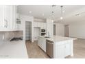 Bright, modern kitchen with stainless steel appliances, white cabinets, and a center island at 24134 N 172Nd Ave, Surprise, AZ 85387