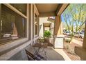 Inviting front porch with neutral color, seating area, and desert landscaping, offering a cozy outdoor space at 2484 N Stone Hill Rd, Buckeye, AZ 85396