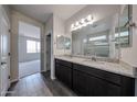 Elegant bathroom featuring a double sink vanity with granite countertops and a large mirror at 2514 E Music Mountain Ave, Apache Junction, AZ 85119