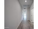 Inviting hallway featuring stylish wood-look tile flooring and a bright, airy atmosphere at 2514 E Music Mountain Ave, Apache Junction, AZ 85119