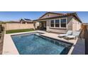 Inviting backyard pool with lounge chairs and a covered patio, perfect for relaxation and outdoor entertaining at 26978 N 74Th Ln, Peoria, AZ 85383
