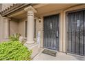 Close-up of the front door with security gate, welcome mat, and charming 'Home Sweet Home' decor at 3491 N Arizona Ave # 167, Chandler, AZ 85225