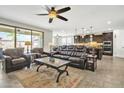 Open-concept living room is bright with natural light and combines with the kitchen for seamless entertaining at 3690 E Blue Spruce Ln, Gilbert, AZ 85298