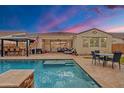 Inviting backyard pool and patio area with lush landscaping and comfortable seating, perfect for outdoor living at 3690 E Blue Spruce Ln, Gilbert, AZ 85298