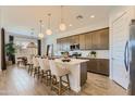 Open-concept kitchen featuring an island with seating, pendant lighting, and modern cabinetry at 3735 E Kenley Ln, San Tan Valley, AZ 85143