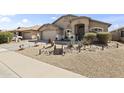 Inviting single-level home featuring desert landscaping, a decorative bridge, and a welcoming entrance at 40729 W Coltin Way, Maricopa, AZ 85138