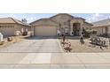 Attractive single-story home boasts a two-car garage and drought-tolerant landscaping with decorative touches at 40729 W Coltin Way, Maricopa, AZ 85138