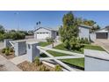 Inviting home with well-kept lawn, stylish fence, and attached garage offering a blend of comfort and functionality at 4402 E Montecito Ave, Phoenix, AZ 85018