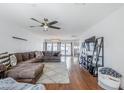 Spacious living room with hardwood floors, ceiling fan, and a large sectional sofa perfect for relaxation at 4402 E Montecito Ave, Phoenix, AZ 85018
