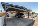 A carport providing shaded parking beside a charming single-story home with a white exterior at 4521 W Clarendon Ave, Phoenix, AZ 85031