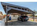 A carport providing shaded parking beside a charming single-story home with a white exterior at 4521 W Clarendon Ave, Phoenix, AZ 85031