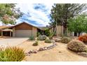 Charming single-story home featuring desert landscaping and a two-car garage at 4839 E Marilyn Rd, Scottsdale, AZ 85254
