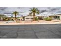 Inviting single-story home with palm trees, low maintenance landscape, and a well-kept exterior at 5524 E Harmon Cir, Mesa, AZ 85215