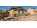 Exterior side view featuring manicured landscaping, complemented by neutral colors at 6822 W Alta Vista Rd, Laveen, AZ 85339