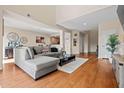 Open-concept living room with wood flooring, neutral paint, and comfortable sectional sofa at 705 W Queen Creek Rd # 1201, Chandler, AZ 85248