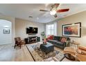 Comfortable living room with wood floors, a ceiling fan, and neutral wall paint at 7822 S 15Th Way, Phoenix, AZ 85042
