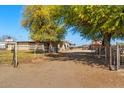 Charming home with mature trees, open front yard, and gated entrance offering privacy at 836 W Lenora Way, San Tan Valley, AZ 85140