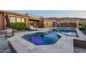 Backyard featuring a pool, spa, pergola, seating, spiral staircase, and mountain views at 8504 S 30Th St, Phoenix, AZ 85042