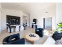 Open-concept living and dining area with sleek furnishings, light wood floors, and contemporary lighting fixtures at 9238 E Palm Tree Dr, Scottsdale, AZ 85255
