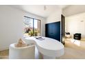 Bright office space with a unique desk, a comfortable chair, and a view of the outdoors at 9238 E Palm Tree Dr, Scottsdale, AZ 85255