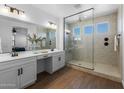 Elegant bathroom showcasing a glass-enclosed shower, dual sinks, and vanity area at 9718 E Radioactive Dr, Mesa, AZ 85212