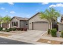 Beautiful single-Gathering home with manicured landscaping and a two-car garage on a sunny day at 9738 E Tiburon Ave, Mesa, AZ 85212