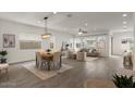 Open-concept living area featuring tile floors, a dining area, and comfortable seating at 9738 E Tiburon Ave, Mesa, AZ 85212