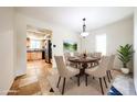 Bright dining room featuring a round table, elegant chairs, and a view to the kitchen at 11221 N 32Nd St, Phoenix, AZ 85028