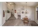 Spacious living room featuring tiled floors, carpeted area, staircase, and stylish decor accents at 14406 N 129Th Ave, El Mirage, AZ 85335